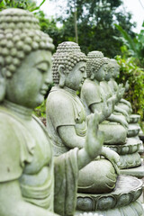 Fototapeta premium Stone buddha statue, close up. Buddhism.