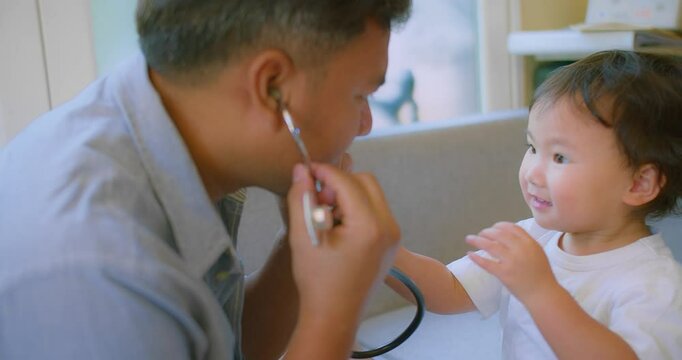 cute small child and father game as Doctor holding Stethoscope listening to father patient pretending nurse having fun with dad in cozy living room at home, capturing a heartwarming family moment.