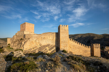 Naklejka premium Views of the defensive enclosure of the medieval walls of Albarracín, Teruel, Aragon, Spain, with golden evening light