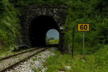 Railroad tracks, tunnel with train tracks, railway signs, ancient railway crossing, vintage train, curved lines.