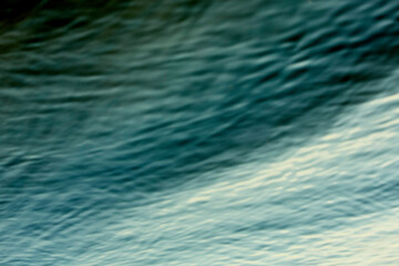 Abstract blur of ocean waves with gradient shades of blue.