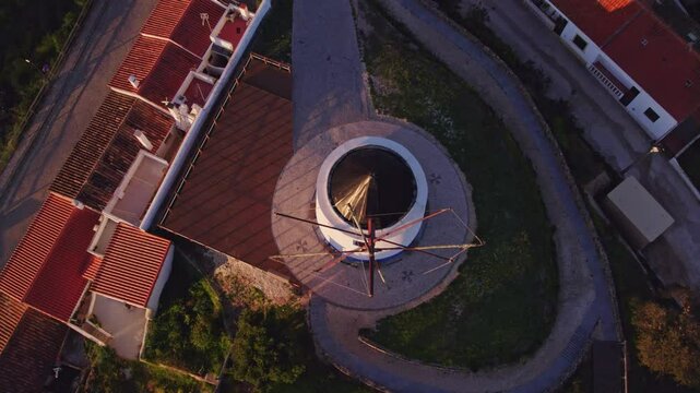 Aerial view of traditional village with windmill during sunrise, Odeceixe, Faro, Portugal.