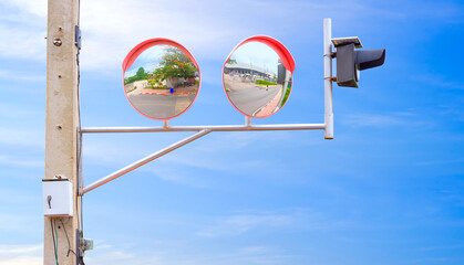 2 convex traffic mirrors with solar cell LED warning light on electric pole at the entrance and exit way of factory for increasing road safety