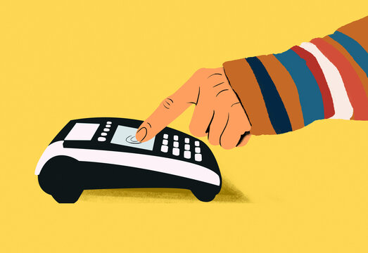 A hand pressing a button on a desktop telephone against a yellow background.