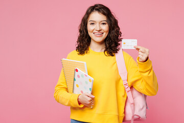 Young smiling happy teen girl student she wears yellow casual clothes backpack bag hold books...