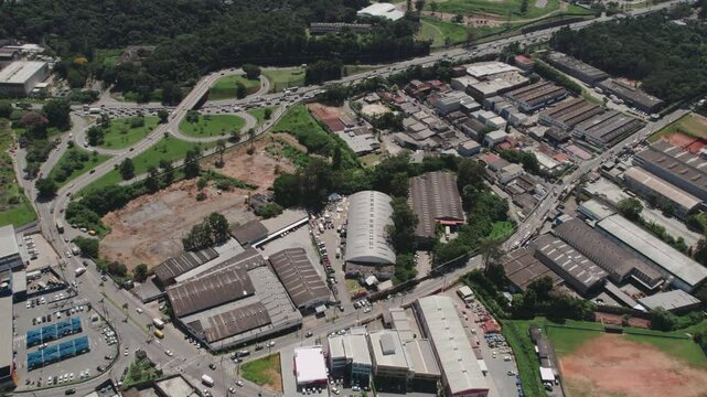 Aerial view of Cotia, S&atilde;o Paulo, Brazil, showcasing vibrant urban sprawl with lush greenery.