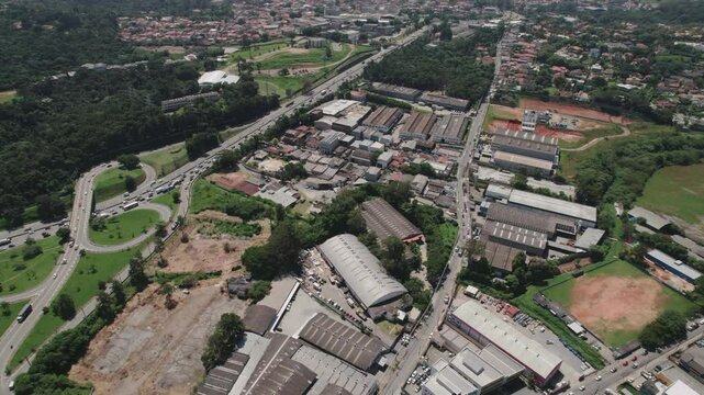 Aerial view of Cotia, S&atilde;o Paulo, Brazil, showcasing vibrant urban sprawl with lush greenery.