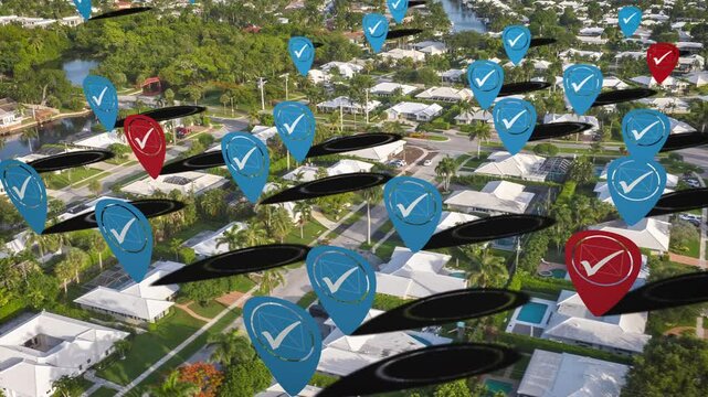 Residential housing development with blue and red checkmark icons hovering over homes for presidential voting preferences in USA. Democrat-heavy neighborhood. Aerial animated hyper lapse.