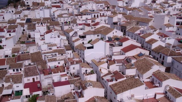 Aerial view of picturesque town, church, and castle in white Andalusian village, Olvera, Cadiz, Spain.