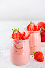 Mousse tofu soy dessert with strawberry in a glass cups. Lactose and sugar free. Vertical orientation.