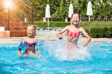 Pool for Kids in Hotel. Happy Children Having Fun in Swimming Pool in Summer Holiday.