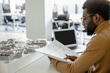 Professional man architect creating exterior designs in the workplace