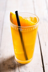 Orange vodka cocktail on wooden table