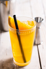 Orange vodka cocktail on wooden table
