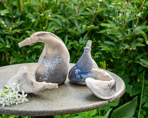 still life with decorative earthenware on a background of green plants, handmade, artisan concept, interior items,  decor