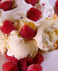 Female hands cutting belgian waffles topped with whipped cream with fork and knife. High quality 4k footage