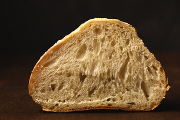 Delicious homemade bread cut in half. Still life in a rustic style, close-up