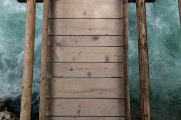 Vintgar Gorges Park a few km from Lake Bled, Slovenia. Wooden walkways accompany the path above the river rapids and waterfalls. River hits rocks and creates fog.Adventure family holidays. Freshness.