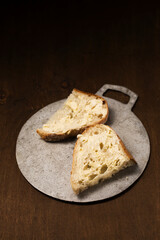 Two slices of homemade bread spread with butter. Still life in a rustic style
