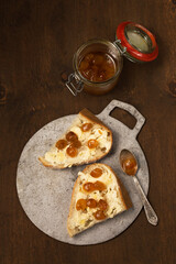 Dessert of homemade bread, butter and yellow cherry jam. Still life in a rustic style