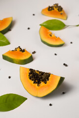 Fruit background made of pieces of ripe papaya on a white