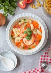 Home made macaroni with shrimp or pasta soup in a white ceramic bowl , top view food table