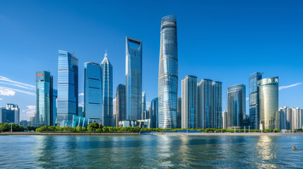 Obraz premium Panoramic view of skyscrapers against a bright blue sky. The city skyline shows tall buildings and modern architecture.