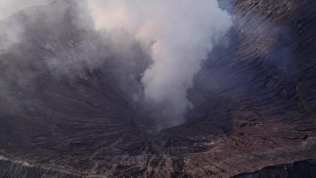 Aerial view of smoking volcano crater at sunrise, Bromo, East Java, Indonesia.