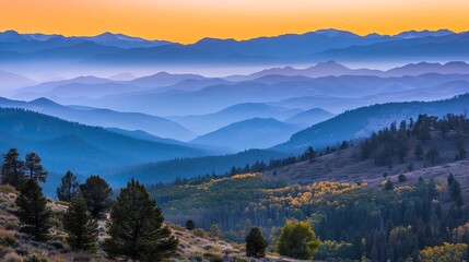 Obraz premium A view of a mountainous landscape with a warm sunset sky.