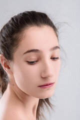 Fototapeta premium Young woman with natural beauty is posing on grey background