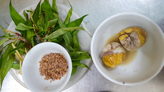 Boiled Baluts (Hột Vịt Lộn In Vietnamese) With Laksa Leaves, Salt And Pepper.
