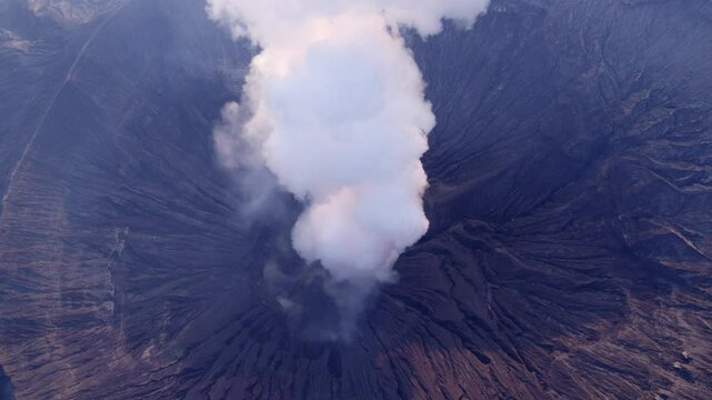 Aerial view of smoking volcano crater at sunrise, Bromo, East Java, Indonesia.