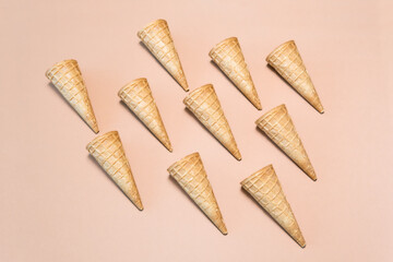 Waffle cones arranged on a beige background in a flat lay composition.