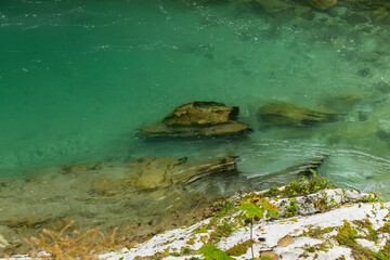 Vintgar Gorges Park a few km from Lake Bled, Slovenia. Wooden walkways accompany the path above the river rapids and waterfalls. River hits rocks and creates fog.Adventure family holidays. Freshness.