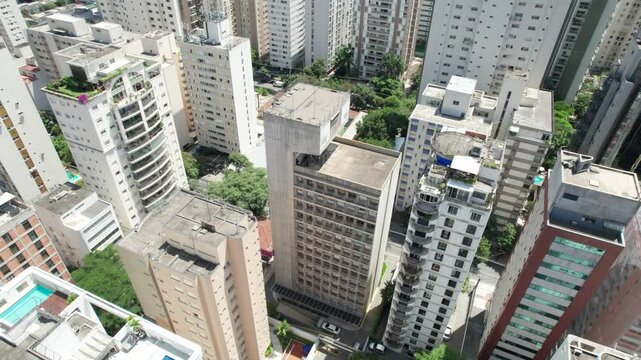 Aerial view of Itaim Bibi, S&atilde;o Paulo, Brazil. Features a dense cluster of high-rise residential and commercial buildings, green spaces, and a panoramic cityscape.