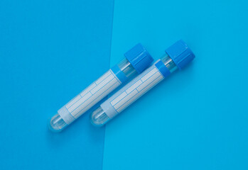 Medical empty blood tubes on blue background