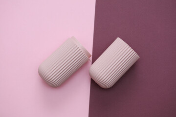 Plastic case organizer for makeup brushes or small accessories on a pink burgundy background