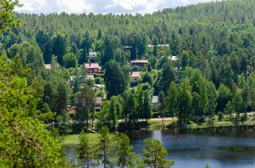 A village build in hillside in Finland. Scenic homes in the Finnish Säynätsalo forest. Nice tourist spot view with lake and clean water. 