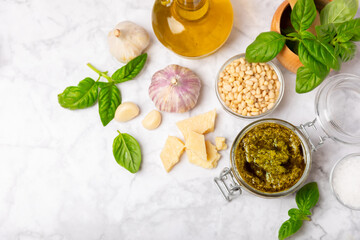 Pesto. Italian basil pesto sauce on a textured wooden background. Ingredient for pesto sauce: fresh...