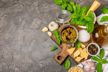 Pesto. Italian basil pesto sauce on a textured wooden background. Ingredient for pesto sauce: fresh...