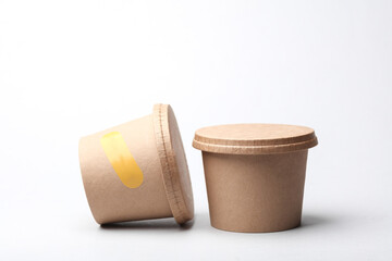 Craft take-away take-out food paper containers, cardboard round disposable packaging boxes on white background