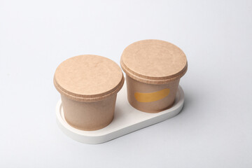 Craft take-away take-out food paper containers, cardboard round disposable packaging boxes on white background