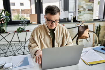 Young man with Down syndrome works at desk in home office, focused on laptop - Powered by Adobe