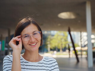 Asian woman over background of modern urban architecture in Vienna.