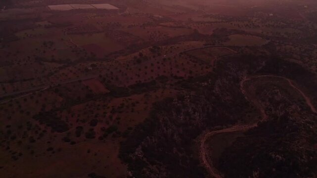 Aerial view of foggy countryside fields at sunrise, Ginosa, Italy.