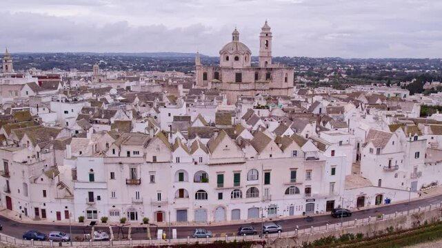 Aerial view of charming white village with church rooftops, Locorotondo, Italy.