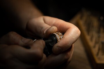 craftsman making diamond ring. hand made jewelery. Put diamond gem ring. diamond ring production craftman workshop. solitaire ring making