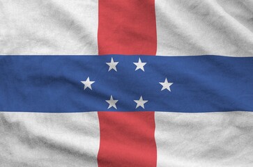 Netherlands Antilles flag depicted on folded wavy fabric of old cloth close up
