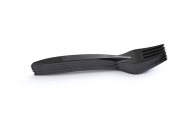 Black plastic forks on a white background
