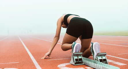 Start, fitness or back of woman on race track for run, competitive or sprint in arena. Challenge,...